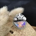 Vintage starfish shell ring with iridescent opal stone on textured mineral rock - Colorful Stone Ring