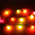 LED apple-shaped Christmas lights with red and yellow spheres and green leaves on wood - Fruit Shape Lights