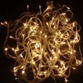 Cluster of warm white LED Christmas lights with transparent cable on dark background - 80L Warm Light