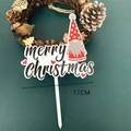 Detail showing acrylic Christmas gnome cake topper with Merry Christmas text on dark background - White Base Style D