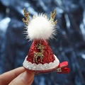 Red sequin Christmas hat hair clip with golden antlers and fluffy white pom-pom detail - 16 Sequin Christmas Hat with Gold Antler and White Pom Pom