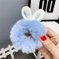 Detailed view of a soft blue plush hair scrunchie with cute white rabbit ears design - Rabbit Ears Style / Sky Blue