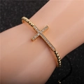 Close-up of gold-plated cross bracelet with micro-p鑲ed zircons on a beaded cord - Cross / Gold