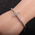 Detail of adjustable beaded cross bracelet set with micro-pave zircons on a male wrist - Cross / White Gold