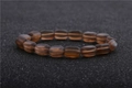Macro shot of dark brown moonstone beads with matte texture on black textured background - Dark Brown Frosted Style (7)