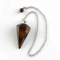 Macro detail of hexagonal tiger eye stone pendulum with silver chain and bead - Tiger Eye With Bead Chain