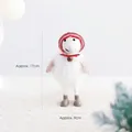 Handgefertigte Schafpuppe aus weißem Wollfilz mit roter Strickmütze und Glocke - Frau Weihnachtsmann (Schaf)