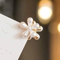 Elegant six-petal pearl flower clip with golden metal base on a white display card - Small Flower Claw