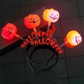 Detail view of Halloween LED pumpkin headband with spring attachments and light-up feature - Letter Pumpkin