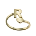 Detail of gold open ring featuring letter R and heart design on white background - Letter R / Gold