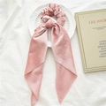Detail of pink velvet scrunchie with long chiffon ribbons on an artistic background - Pink Velvet Streamer