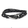 Close-up of nautical multi-layer woven rope bracelet with polished silver fish hook clasp - Black White Dots / Silver Hook