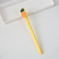Yellow cartoon gel pen with pineapple silicone topper on white background - Pineapple