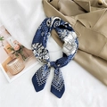 Navy blue silk square scarf with white paisley and horse patterns on khaki trench coat - 14 Carriage Paisley Navy Blue