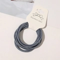 Detail of blue high-elastic hair tie bundled on white card with stainless steel joint - Denim Blue