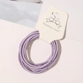 Macro shot of elastic purple hair ties wrapped on white Stainless Steel display card - Lavender Purple