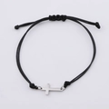 Detalle de pulsera ajustable de cuerda negra trenzada con un dije de cruz de acero - Color Acero (MP038)
