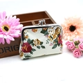Detail of vintage canvas rose coin purse with a classic metal kiss-lock closure - White