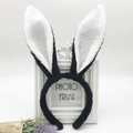Close-up of white and black plush rabbit ear headbands with soft sequins and lavender - Black and White Rabbit