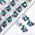 Macro detail of faceted 14mm butterfly crystal pendants for DIY jewelry making - Grass Red