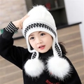 White children's knitted earflap hat featuring black and white houndstooth trim and white pom-poms - White