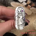 Macro shot of vintage silver Aquarius ring featuring floral patterns and purple gemstones - Aquarius