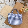 Blue and white checkered canvas tote bag on a wooden table in a lifestyle setting - Blue