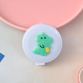 Mini retractable tape measure with a cute green dinosaur design in a round white casing - Dinosaur