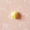 Detail of a yellow resin chick charm with pink bowknot for DIY craft and phone case decor - Yellow Chick