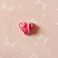 Macro detail of heart-shaped pink resin charm with blue 3D swirl texture for DIY crafts - Rose Red Heart