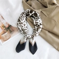Elegant leopard print satin silk square scarf styled with a classic trench coat - 24 Ink Leopard Black