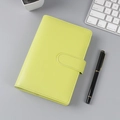 Detail of neon green leather notebook with magnetic buckle on a grey workspace desk - A6 No Inner Pages / Apple Green