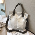 Minimalist beige canvas tote bag with brown straps and dual front pockets - White Without Charm