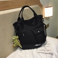Black canvas tote bag with dinosaur charm, functional crossbody strap and sport label - Black With Dinosaur Charm
