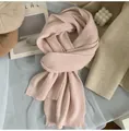 Close-up of soft pink knitted scarf with vertical rib texture in a cozy scene - Cream Pink