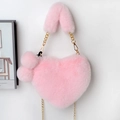 Detailed view of pink heart-shaped plush handbag with fluffy charms and gold chain - Light Pink