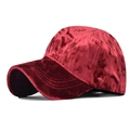 Close-up of luxury red velvet baseball cap with a premium soft texture and curved brim - Chenille Red