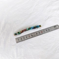 Detail shot of a 11.5cm acetate hair clip with colorful marbled pattern next to a ruler - Green Floral