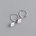 Macro detail of S925 sterling silver hoop earrings with rhombic zircon star pendants - 925 Silver / White Gold (Pair)
