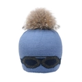 Détail du bonnet en tricot bleu avec un grand pompon en fourrure et motif lunettes - Bleu-Pompon Fourrure Raton Laveur