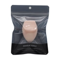 Detailed view of pink makeup sponge in transparent retail packaging with brand logo - Self-sealing Bag / Nude