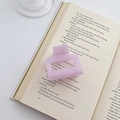 Matte translucent purple square hair claw clip placed on a vintage book page - Violet