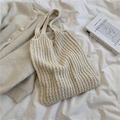 Beige oversized knitted tote bag with textured weave pattern on a white bedsheet - White