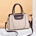 Minimalist beige and burgundy leather shoulder bag with gold hardware on exhibition stand - Handbag/Crossbody Bag / Off White