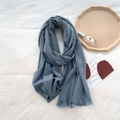 Detail of soft dark grey blue cashmere scarf featuring delicate short fringe tassels - Creamy Blue