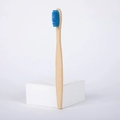 Einzelne Bambus Zahnbürste mit blauen Borsten auf einem minimalistischen weißen Ständer - Blau