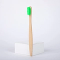 Eco-friendly bamboo toothbrush with natural wooden handle and soft green nylon bristles - Green