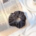 Dark grey velvet scrunchie for hair with a soft texture on a lifestyle background - Gray