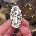 Macro shot of vintage Sagittarius ring with turquoise stone and celestial relief engraving - Sagittarius