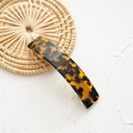 Detailed view of rectangle acetate hair clip with tortoise shell pattern on woven mat - Acetate Deep Tortoise Shell